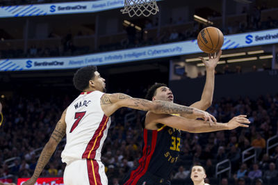 Jan 7, 2025; San Francisco, California, USA;  Miami Heat center Kel'el Ware (7) fouls Golden State Warriors forward Trayce Jackson-Davis (32) during the third quarter at Chase Center. Mandatory Credit: John Hefti-Imagn Images