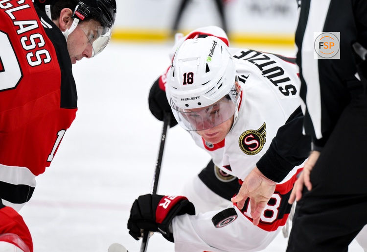 Oct 12, 2026; Newark, New Jersey, USA;  Ottawa Senators center Tim Stutzle (18) faces off against New Jersey Devils center Cody Glass (12) during the first period at Prudential Center.  Credit: John Jones-Imagn Images