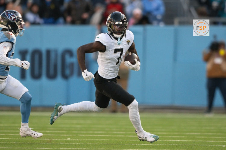 Nov 30, 2025; Nashville, Tennessee, USA;  Jacksonville Jaguars wide receiver Brian Thomas Jr. (7) runs with the ball after a made catch against the Tennessee Titans during the second half at Nissan Stadium. Credit: Steve Roberts-Imagn Images