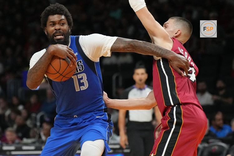 Nov 24, 2025; Miami, Florida, USA; Dallas Mavericks forward Naji Marshall (13) drives past Miami Heat guard Tyler Herro (14) during the second half at Kaseya Center. Credit: Jim Rassol-Imagn Images