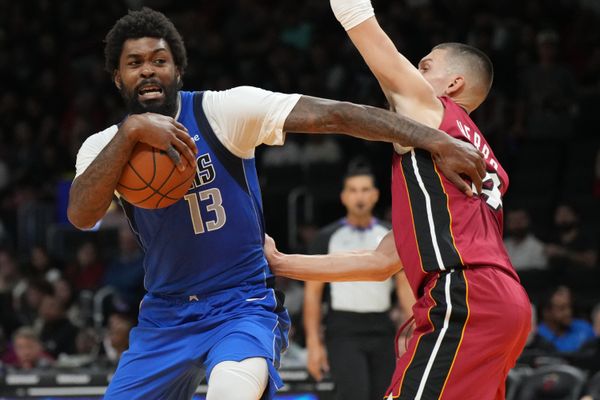 Nov 24, 2025; Miami, Florida, USA; Dallas Mavericks forward Naji Marshall (13) drives past Miami Heat guard Tyler Herro (14) during the second half at Kaseya Center. Mandatory Credit: Jim Rassol-Imagn Images