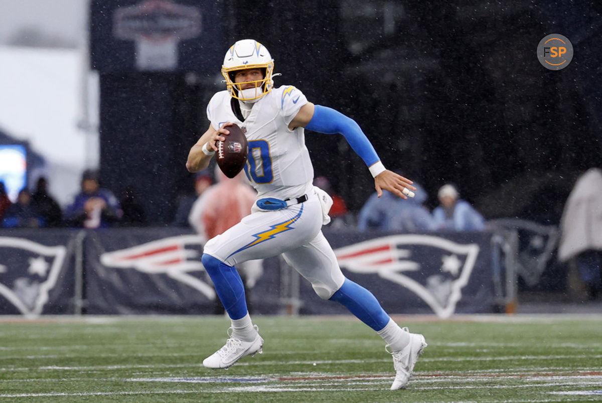 FOXBOROUGH, MA - DECEMBER 03: Los Angeles Chargers quarterback Justin Herbert (10) rolls out during a game between the New England Patriots and the Los Angeles Chargers on December 3, 2023, at Gillette Stadium in Foxborough, Massachusetts. (Photo by Fred Kfoury III/Icon Sportswire)