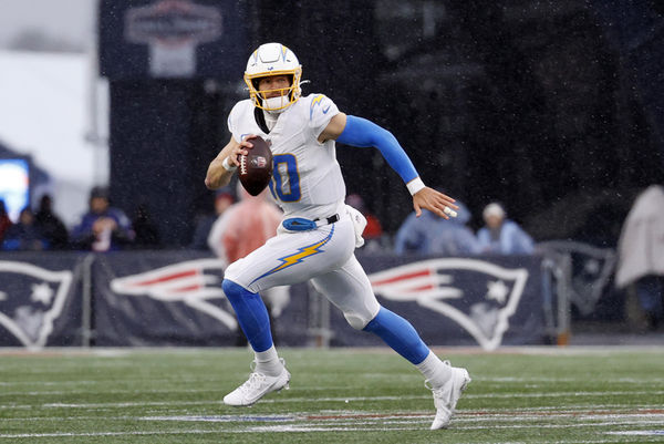 FOXBOROUGH, MA - DECEMBER 03: Los Angeles Chargers quarterback Justin Herbert (10) rolls out during a game between the New England Patriots and the Los Angeles Chargers on December 3, 2023, at Gillette Stadium in Foxborough, Massachusetts. (Photo by Fred Kfoury III/Icon Sportswire)