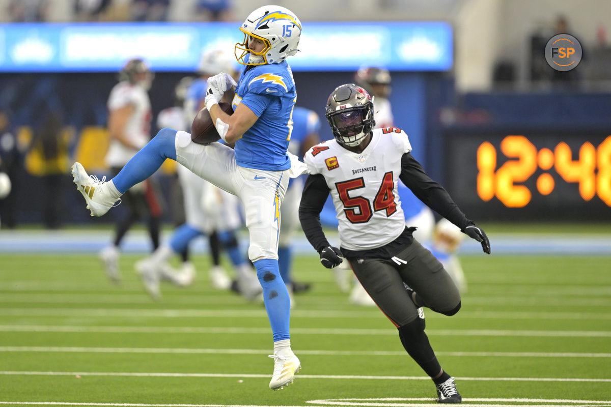 Dec 15, 2024; Inglewood, California, USA;  Los Angeles Chargers wide receiver Ladd McConkey (15) hangs on to the ball for a complete in front of Tampa Bay Buccaneers linebacker Lavonte David (54) in the first half at SoFi Stadium. Credit: Jayne Kamin-Oncea-Imagn Images