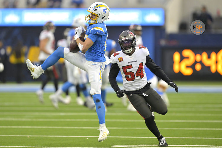 Dec 15, 2024; Inglewood, California, USA;  Los Angeles Chargers wide receiver Ladd McConkey (15) hangs on to the ball for a complete in front of Tampa Bay Buccaneers linebacker Lavonte David (54) in the first half at SoFi Stadium. Credit: Jayne Kamin-Oncea-Imagn Images