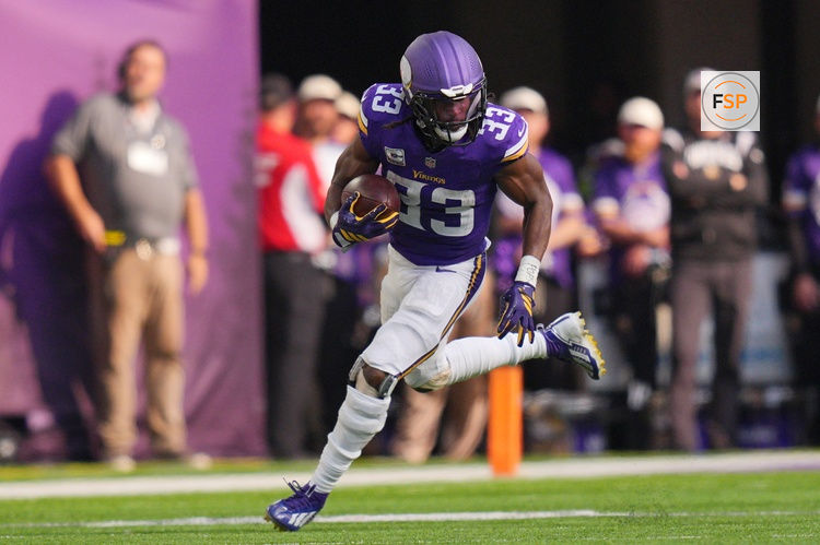 Oct 4, 2026; Minneapolis, Minnesota, USA;  Minnesota Vikings running back Aaron Jones (33) runs after making a catch during the second quarter against the Miami Dolphins at U.S. Bank Stadium.  Credit: Brad Rempel-Imagn Images