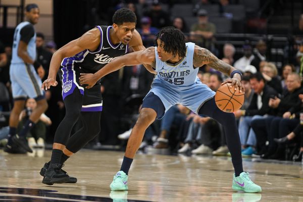 Feb 4, 2026; Sacramento, California, USA; Memphis Grizzlies forward GG Jackson (45) dribbles against Sacramento Kings forward De’Andre Hunter (15) during the fourth quarter at Golden 1 Center. Mandatory Credit: Ed Szczepanski-Imagn Images
