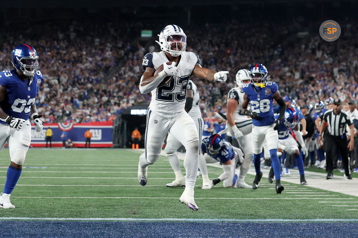 Sep 26, 2024; East Rutherford, New Jersey, USA; Dallas Cowboys running back Rico Dowdle (23) celebrates his touchdown against the New York Giants during the first quarter at MetLife Stadium. Credit: Brad Penner-Imagn Images