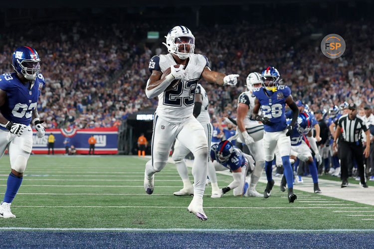 Sep 26, 2024; East Rutherford, New Jersey, USA; Dallas Cowboys running back Rico Dowdle (23) celebrates his touchdown against the New York Giants during the first quarter at MetLife Stadium. Credit: Brad Penner-Imagn Images