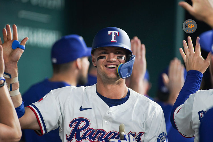 May 13, 2025; Arlington, Texas, USA; Texas Rangers third baseman Josh Jung (6) is greeted in the dugout after hitting a three-run home run during the first inning against the Colorado Rockies at Globe Life Field. Credit: Raymond Carlin III-Imagn Images