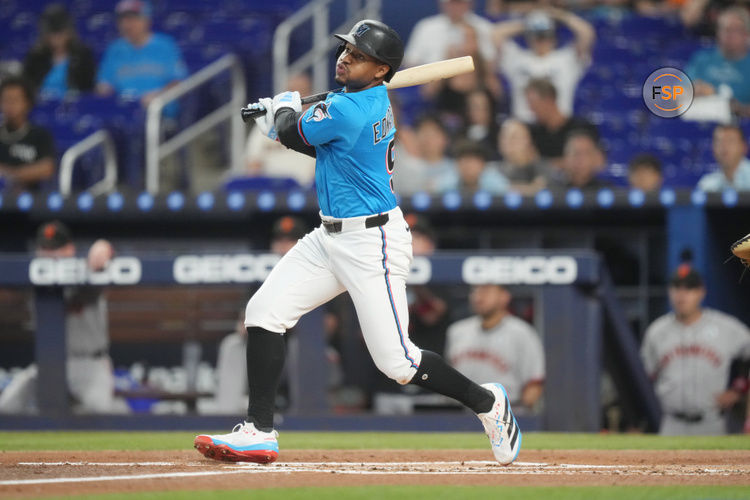 Jun 1, 2025; Miami, Florida, USA;  Miami Marlins second baseman Xavier Edwards (9) hits a double in the first inning against the San Francisco Giants at loanDepot Park. Credit: Jim Rassol-Imagn Images
