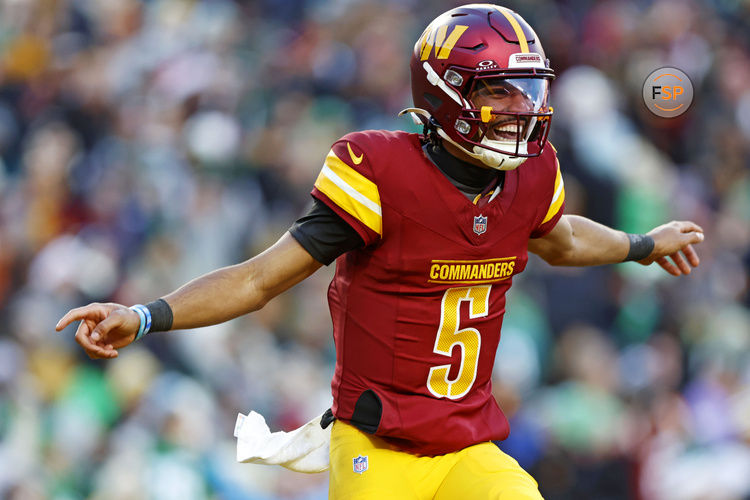 Dec 22, 2024; Landover, Maryland, USA; Washington Commanders quarterback Jayden Daniels (5) celebrates after throwing a touchdown during the fourth quarter against the Philadelphia Eagles at Northwest Stadium. Credit: Peter Casey-Imagn Images