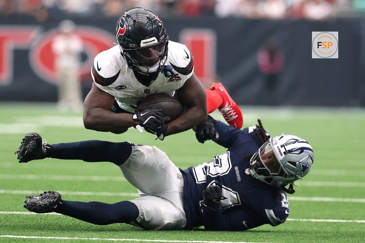 Oct 4, 2026; Houston, Texas, USA;  Houston Texans running back Woody Marks (4) is tackled Dallas Cowboys safety Malik Hooker (24) during the second half at Reliant Stadium.  Credit: Troy Taormina-Imagn Images     TPX IMAGES OF THE DAY     