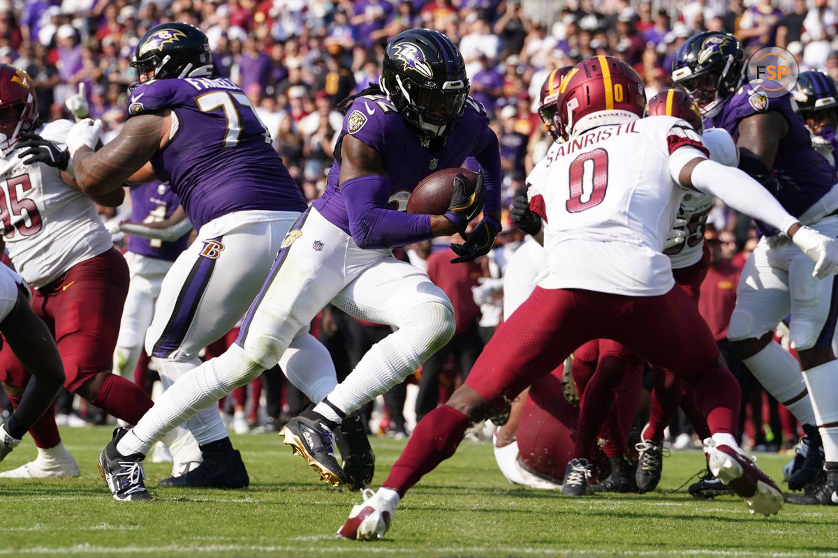 Oct 13, 2024; Baltimore, Maryland, USA; Baltimore Ravens running back Derrick Henry (22) scores a third quarter touchdown against the Washington Commanders at M&T Bank Stadium. Credit: Mitch Stringer-Imagn Images