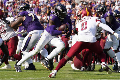 Oct 13, 2024; Baltimore, Maryland, USA; Baltimore Ravens running back Derrick Henry (22) scores a third quarter touchdown against the Washington Commanders at M&T Bank Stadium. Mandatory Credit: Mitch Stringer-Imagn Images