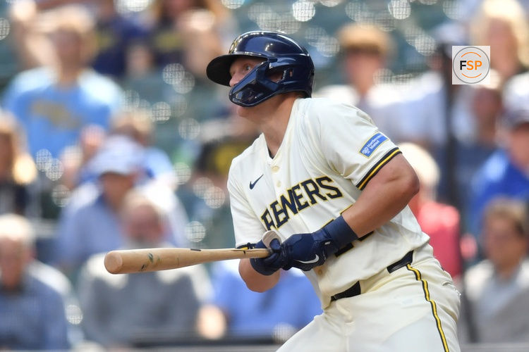Jul 9, 2025; Milwaukee, Wisconsin, USA; Milwaukee Brewers pinch hitter Andrew Vaughn (28) hits an RBI single during the ninth inning against the Los Angeles Dodgers at American Family Field. Credit: Patrick Gorski-Imagn Images
