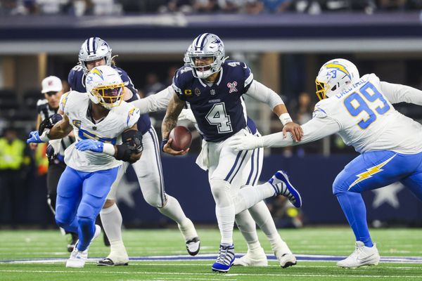 Dec 21, 2025; Arlington, Texas, USA; Dallas Cowboys quarterback Dak Prescott (4) scrambles between Los Angeles Chargers linebacker Khalil Mack (52) and defensive tackle Jamaree Caldwell (99) during the first quarter at AT&T Stadium. Mandatory Credit: Kevin Jairaj-Imagn Images