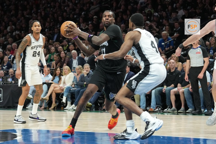 May 15, 2026; Minneapolis, Minnesota, USA; Minnesota Timberwolves center Naz Reid (11) drives to the basket as San Antonio Spurs guard De'aaron Fox (4) plays defense in the second half during game six of the second round of the 2026 NBA Playoffs at Target Center. Credit: Jesse Johnson-Imagn Images