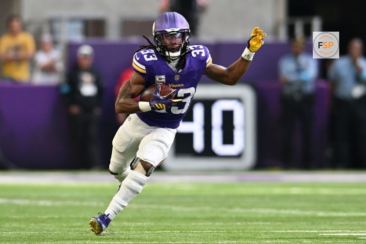 Oct 4, 2026; Minneapolis, Minnesota, USA;  Minnesota Vikings running back Aaron Jones (33) rushes during the second quarter against the Miami Dolphins at U.S. Bank Stadium.  Credit: Jeffrey Becker-Imagn Images