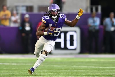 Oct 4, 2026; Minneapolis, Minnesota, USA;  Minnesota Vikings running back Aaron Jones (33) rushes during the second quarter against the Miami Dolphins at U.S. Bank Stadium.  Mandatory Credit: Jeffrey Becker-Imagn Images