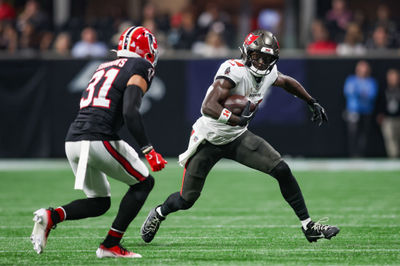 Oct 3, 2024; Atlanta, Georgia, USA; Tampa Bay Buccaneers wide receiver Chris Godwin (14) is pursued by Atlanta Falcons safety Justin Simmons (31) in the first quarter at Mercedes-Benz Stadium. Mandatory Credit: Brett Davis-Imagn Images