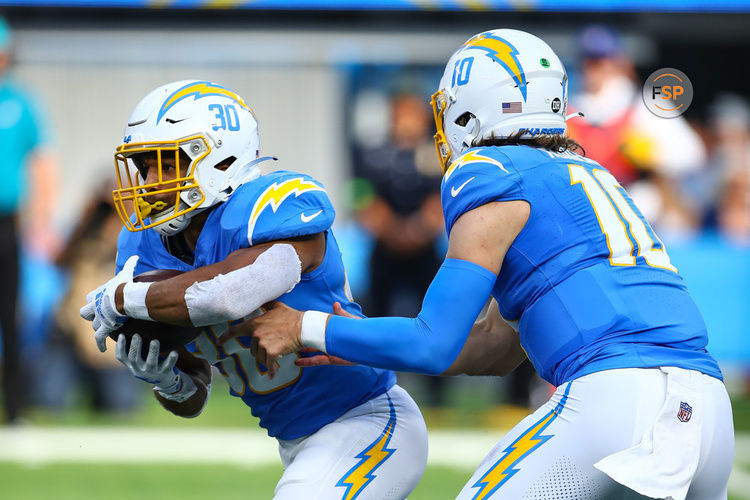 INGLEWOOD, CA - NOVEMBER 12:  Los Angeles Chargers quarterback Justin Herbert (10) hands off to Los Angeles Chargers running back Austin Ekeler (30) during the NFL game between the Detroit Lions and the Los Angeles Chargers on November 12, 2023, at SoFi Stadium in Inglewood, CA. (Photo by Jevone Moore/Icon Sportswire)