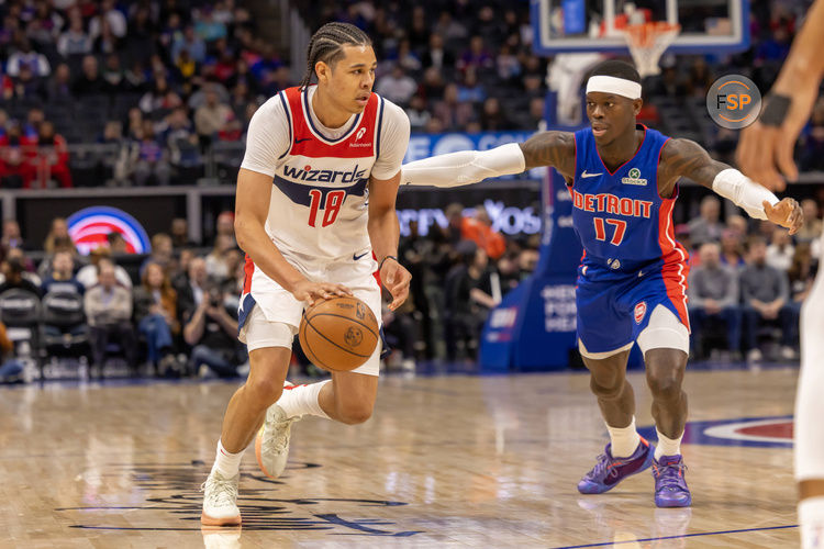 Mar 11, 2025; Detroit, Michigan, USA; Detroit Pistons guard Dennis Schroder (17) defends against Washington Wizards forward Kyshawn George (18) during the first half at Little Caesars Arena. Credit: David Reginek-Imagn Images