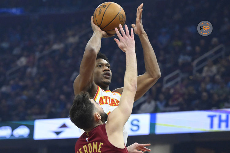 Jan 30, 2025; Cleveland, Ohio, USA; Atlanta Hawks forward De'Andre Hunter (12) shoots beside Cleveland Cavaliers guard Ty Jerome (2) in the first quarter at Rocket Mortgage FieldHouse. Credit: David Richard-Imagn Images