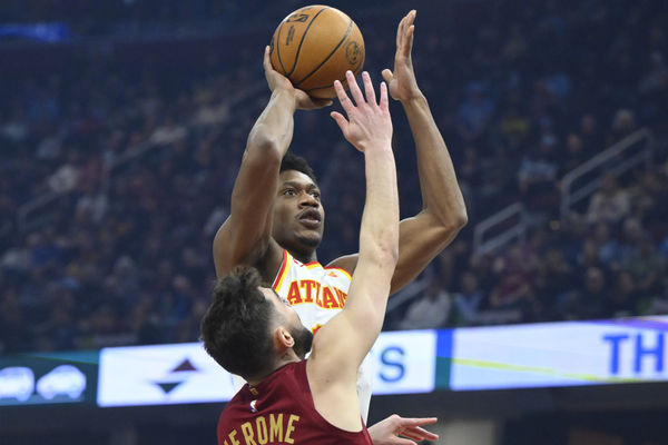 Jan 30, 2025; Cleveland, Ohio, USA; Atlanta Hawks forward De'Andre Hunter (12) shoots beside Cleveland Cavaliers guard Ty Jerome (2) in the first quarter at Rocket Mortgage FieldHouse. Mandatory Credit: David Richard-Imagn Images