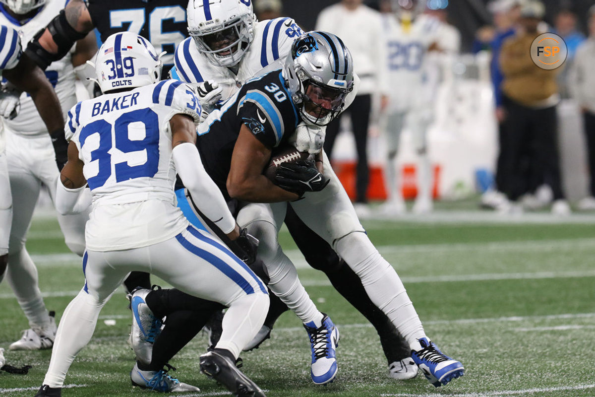 CHARLOTTE, NC - NOVEMBER 05: Carolina Panthers running back Chuba Hubbard (30) is tackled by Indianapolis Colts defensive end Jake Martin (92) during a NFL football game between the Indianapolis Colts and the Carolina Panthers on November 5, 2023 at Bank of America Stadium in Charlotte, N.C.(Photo by John Byrum/Icon Sportswire)
