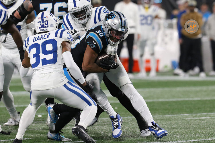 CHARLOTTE, NC - NOVEMBER 05: Carolina Panthers running back Chuba Hubbard (30) is tackled by Indianapolis Colts defensive end Jake Martin (92) during a NFL football game between the Indianapolis Colts and the Carolina Panthers on November 5, 2023 at Bank of America Stadium in Charlotte, N.C.(Photo by John Byrum/Icon Sportswire)
