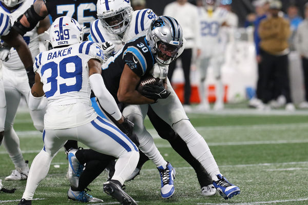 CHARLOTTE, NC - NOVEMBER 05: Carolina Panthers running back Chuba Hubbard (30) is tackled by Indianapolis Colts defensive end Jake Martin (92) during a NFL football game between the Indianapolis Colts and the Carolina Panthers on November 5, 2023 at Bank of America Stadium in Charlotte, N.C.(Photo by John Byrum/Icon Sportswire)
