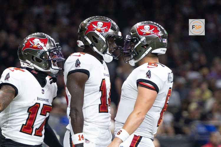 Oct 13, 2024; New Orleans, Louisiana, USA;  Tampa Bay Buccaneers wide receiver Chris Godwin (14) and quarterback Baker Mayfield (6) celebrate a touchdown against the New Orleans Saints during he first half at Caesars Superdome. Credit: Stephen Lew-Imagn Images