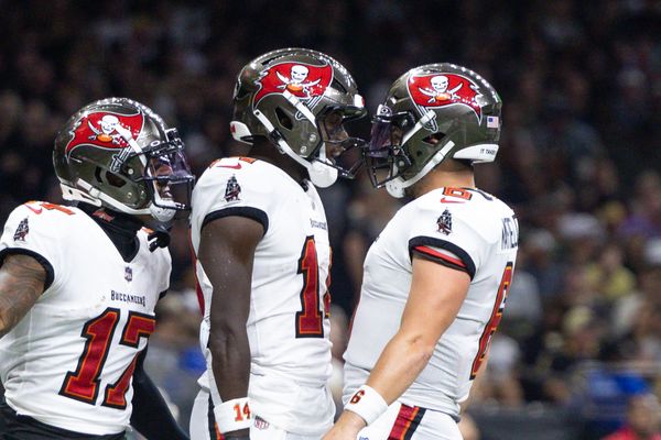 Oct 13, 2024; New Orleans, Louisiana, USA;  Tampa Bay Buccaneers wide receiver Chris Godwin (14) and quarterback Baker Mayfield (6) celebrate a touchdown against the New Orleans Saints during he first half at Caesars Superdome. Mandatory Credit: Stephen Lew-Imagn Images