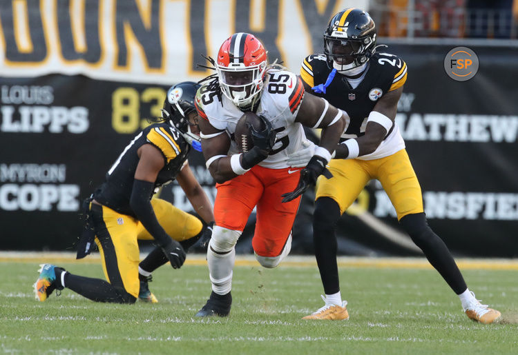 Dec 8, 2024; Pittsburgh, Pennsylvania, USA;  Cleveland Browns tight end David Njoku (85) runs after a catch against Pittsburgh Steelers cornerback Joey Porter Jr. (24) during the fourth quarter at Acrisure Stadium. Credit: Charles LeClaire-Imagn Images