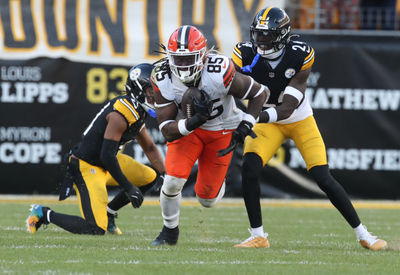 Dec 8, 2024; Pittsburgh, Pennsylvania, USA;  Cleveland Browns tight end David Njoku (85) runs after a catch against Pittsburgh Steelers cornerback Joey Porter Jr. (24) during the fourth quarter at Acrisure Stadium. Mandatory Credit: Charles LeClaire-Imagn Images