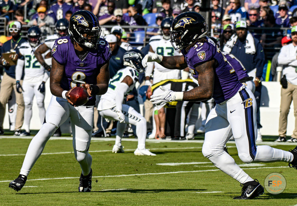 BALTIMORE, MD - NOVEMBER 05:  Baltimore Ravens quarterback Lamar Jackson (8) hands the ball off to running back Gus Edwards (35) during the Seattle Seahawks game versus the Baltimore Ravens on November 5, 2023 at M&T Bank Stadium in Baltimore, MD.  (Photo by Mark Goldman/Icon Sportswire)