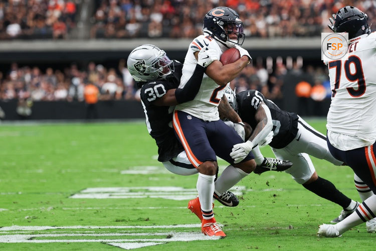 Sep 28, 2025; Paradise, Nevada, USA; Chicago Bears wide receiver DJ Moore (2) is brought down by Las Vegas Raiders cornerback Darnay Holmes (30) and safety Isaiah Pola-Mao (20) during the second quarter at Allegiant Stadium. Credit: Kiyoshi Mio-Imagn Images