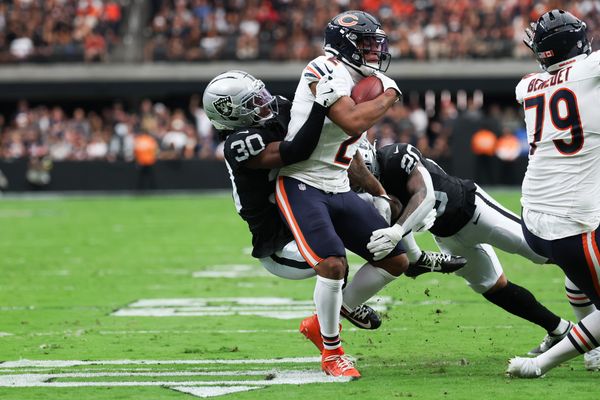 Sep 28, 2025; Paradise, Nevada, USA; Chicago Bears wide receiver DJ Moore (2) is brought down by Las Vegas Raiders cornerback Darnay Holmes (30) and safety Isaiah Pola-Mao (20) during the second quarter at Allegiant Stadium. Mandatory Credit: Kiyoshi Mio-Imagn Images