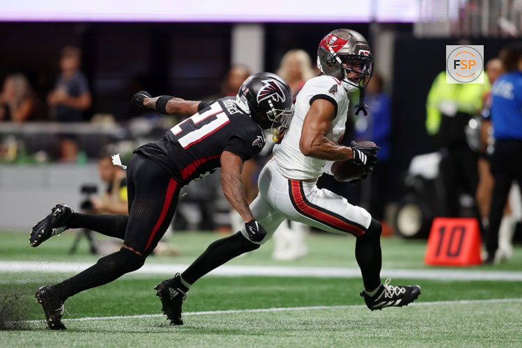 Sep 7, 2025; Atlanta, Georgia, USA; Tampa Bay Buccaneers wide receiver Emeka Egbuka (2) runs with the ball for a touchdown against Atlanta Falcons cornerback Mike Hughes (21) during the second quarter at Mercedes-Benz Stadium. Credit: Brett Davis-Imagn Images