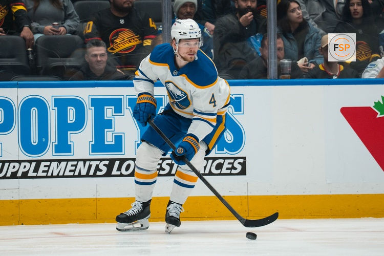 Dec 11, 2025; Vancouver, British Columbia, CAN; Buffalo Sabres defenseman Bowen Byram (4) handles the puck against the Vancouver Canucks in the first period at Rogers Arena. Credit: Bob Frid-Imagn Images