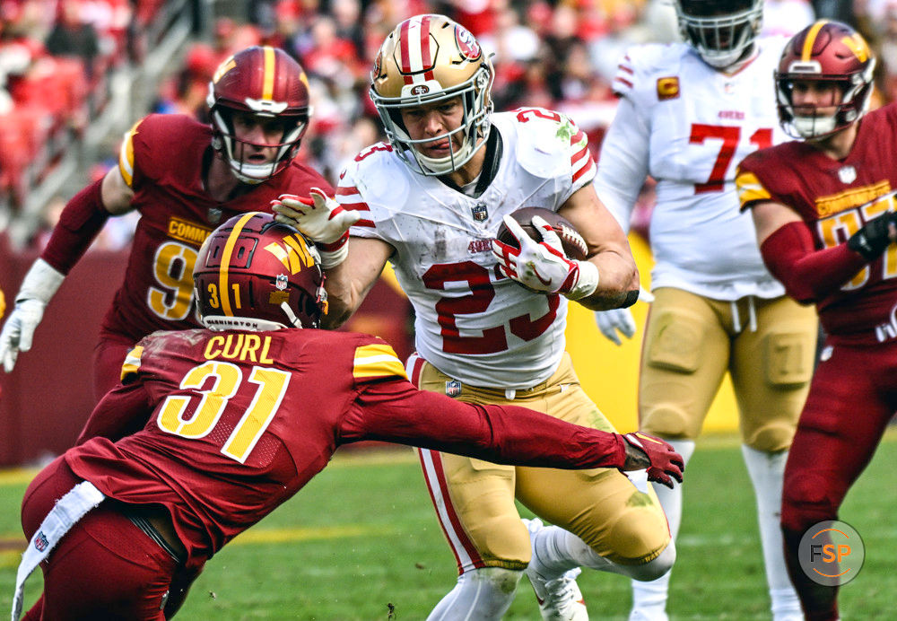 LANDOVER, MD - DECEMBER 31: San Francisco 49ers running back Christian McCaffrey (23) in action against Washington Commanders safety Kamren Curl (31) during the NFL game between the San Francisco 49ers and the Washington Commanders on December 31, 2023 at Fed Ex Field in Landover, MD.  (Photo by Mark Goldman/Icon Sportswire)