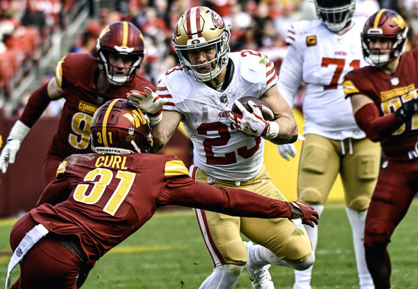 LANDOVER, MD - DECEMBER 31: San Francisco 49ers running back Christian McCaffrey (23) in action against Washington Commanders safety Kamren Curl (31) during the NFL game between the San Francisco 49ers and the Washington Commanders on December 31, 2023 at Fed Ex Field in Landover, MD.  (Photo by Mark Goldman/Icon Sportswire)