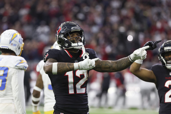 Jan 11, 2025; Houston, Texas, USA;  Houston Texans wide receiver Nico Collins (12) reacts to a first down against the Los Angeles Chargers in the second quarter in an AFC wild card game at NRG Stadium. Mandatory Credit: Thomas Shea-Imagn Images