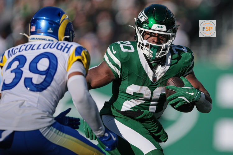 Dec 22, 2024; East Rutherford, New Jersey, USA; New York Jets running back Breece Hall (20) carries the ball asLos Angeles Rams safety Jaylen McCollough (39) pursues during the first half at MetLife Stadium. Credit: Vincent Carchietta-Imagn Images