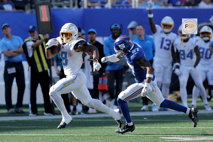 Sep 28, 2025; East Rutherford, New Jersey, USA; Los Angeles Chargers running back Omarion Hampton (8) runs for a touchdown against New York Giants safety Tyler Nubin (27) during the third quarter at MetLife Stadium. Credit: Brad Penner-Imagn Images