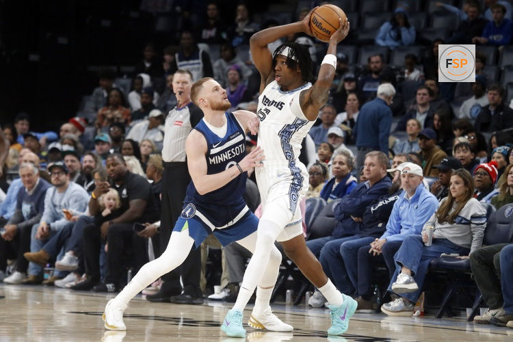 Feb 2, 2026; Memphis, Tennessee, USA; Memphis Grizzlies forward GG Jackson II (45) handles the ball as Minnesota Timberwolves guard Donte DiVincenzo (0) defends during the fourth quarter at FedExForum. Credit: Petre Thomas-Imagn Images