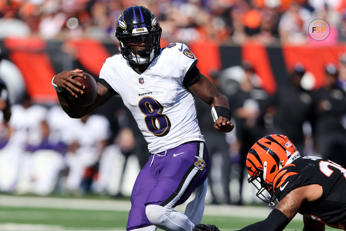 Oct 6, 2024; Cincinnati, Ohio, USA; Baltimore Ravens quarterback Lamar Jackson (8) escapes the tackle of Cincinnati Bengals safety Geno Stone (22) during the second half at Paycor Stadium. Credit: Joseph Maiorana-Imagn Images