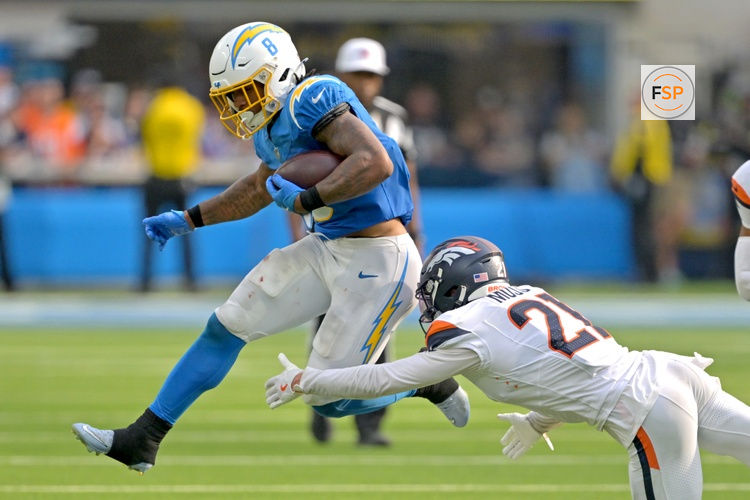 Sep 21, 2025; Inglewood, California, USA;  Los Angeles Chargers running back Omarion Hampton (8) is tripped up by Denver Broncos cornerback Riley Moss (21) after a first down in the fourth quarter at SoFi Stadium. Credit: Jayne Kamin-Oncea-Imagn Images