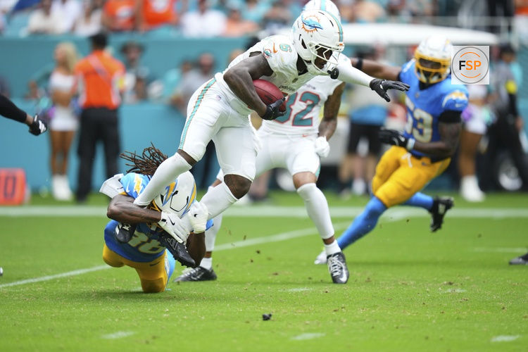 Oct 12, 2025; Miami Gardens, Florida, USA; Los Angeles Chargers cornerback Ja'Sir Taylor (36) tackles Miami Dolphins wide receiver Malik Washington (6) during the third quarter at Hard Rock Stadium. Credit: Rich Storry-Imagn Images